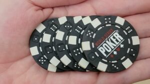 a series of world series of poker chips in a hand