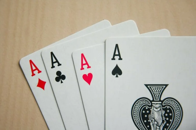 Four ace of spades on a table