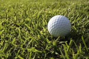 A white golf ball on a field