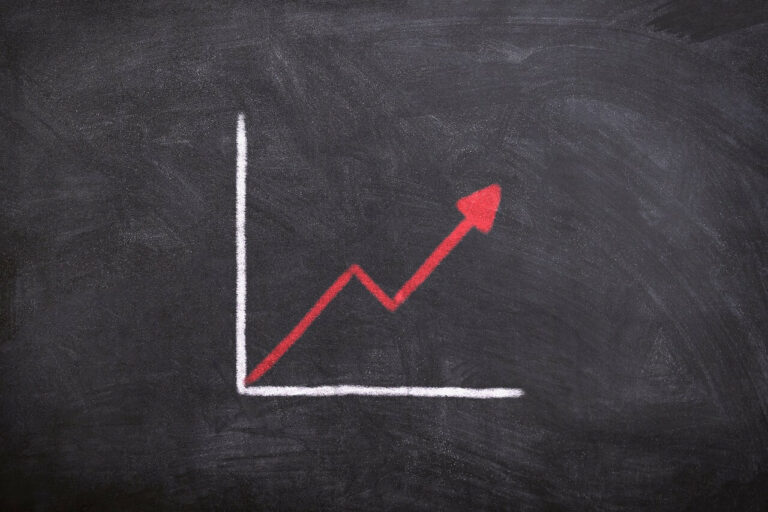 A hand-drawn graph on a black chalkboard