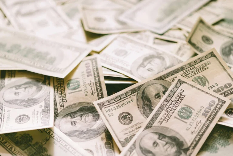 A lot of 100 US dollar notes on a table