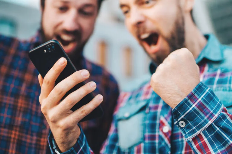 Two people excited about the New York online sports betting launch