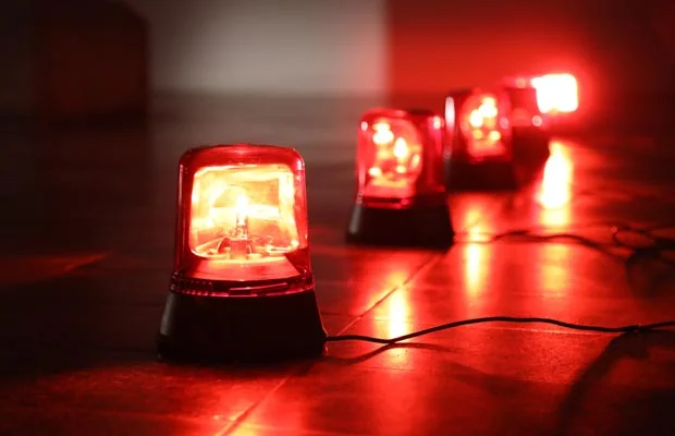 Four lamps with red lights on a floor