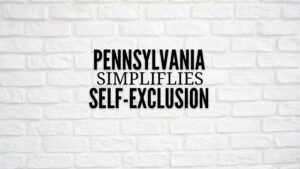 pgcb launches online portal to simplify self-exclusion application. black lettering on white brick wall reads pennsylvania simplifies self-exclusion