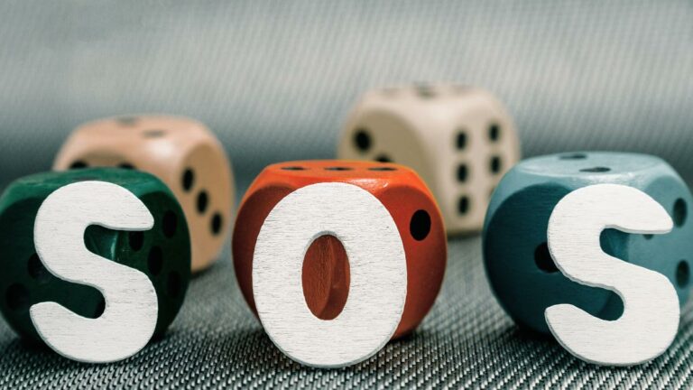 study finds opportunities to offer problem gambling supports. Imge features dice trio overlayed with sos on a textured background