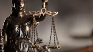 ex-staffer brown drops lawsuit against mgm springfield. broze statue of blind justice holds scale with blurred background