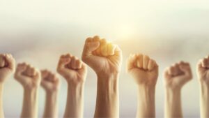 casino workers in vegas and detroit vote to authorize strike. ghands raised in fists punch the air