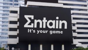 The Entain Logo and Slogan Are on a Billboard