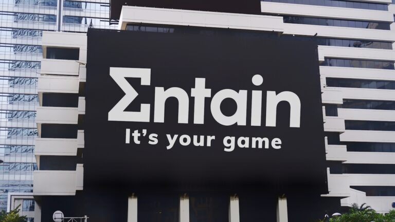 The Entain Logo and Slogan Are on a Billboard