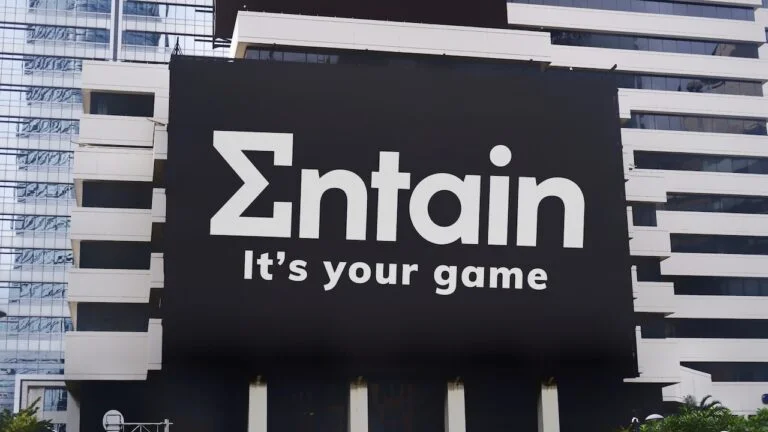 The Entain Logo and Slogan Are on a Billboard