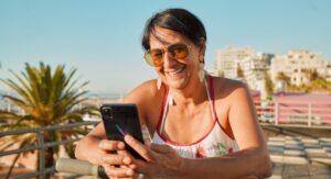 A Florida woman uses her smartphone — perhaps wagering on Hard Rock Bet