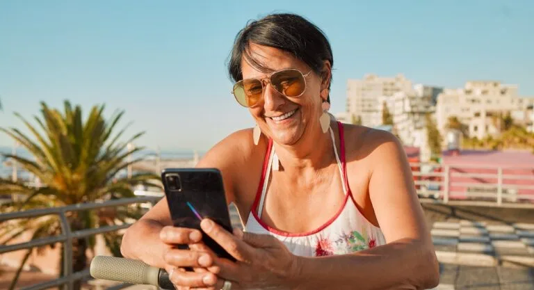 A Florida woman uses her smartphone — perhaps wagering on Hard Rock Bet