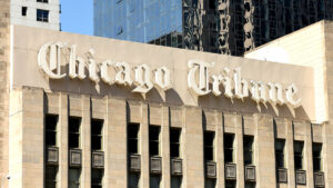 The sign atop the Chicago Tribune publishing plant, which Bally's has begun demolishing to build its permanent waterfront casino.