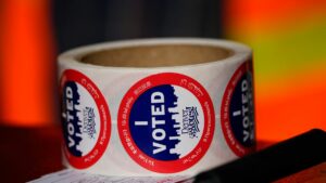 a roll of 'i voted' stickers sitting on a desk