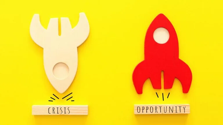 a rocket going down toward crisis and a rocket going up over opportunity