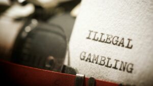 a typewriter that says illegal gambling on a piece of paper