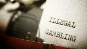 a typewriter that says illegal gambling on a piece of paper