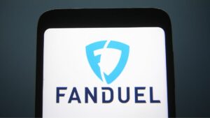 close of of a smart phone showing a white screen with FanDuel's name in navy and pale blue logo on screen