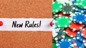 a cork board with new rules pinned to it next to poker chips