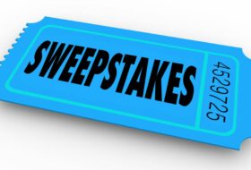 digital illustration of blue raffle-style ticket on white background. Ticket reads sweestakeshorizontally in black, with number in lighter black font appearing vertically on right