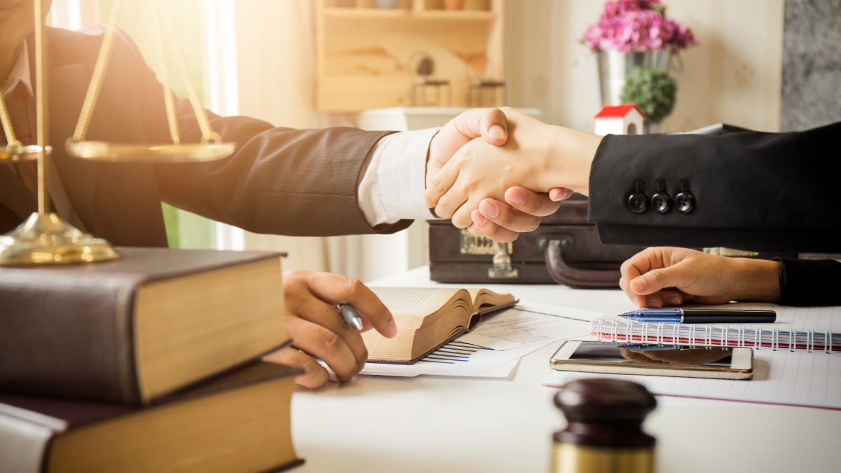 two people shaking hands at a legal office