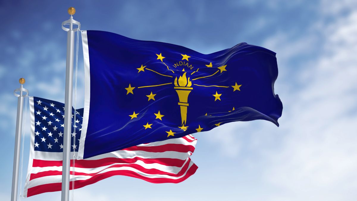 The Indiana state flag flying in front of the US flag