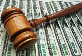 Judge's gavel sits on pile of US $100 dollar bills