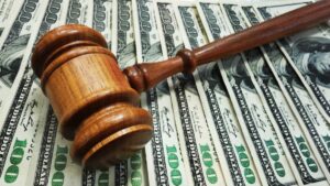 Judge's gavel sits on pile of US $100 dollar bills
