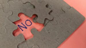 a puzzle missing a piece that says no in the missing spot