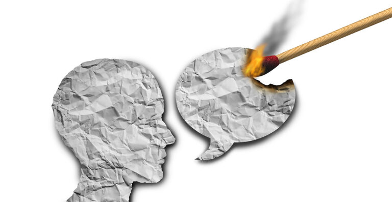 Crumpled paper figure speech bubble match burning silencing debate