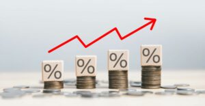 stacks of coins with percentage blocks on them, getting increasingly taller