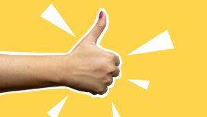 Collage style art. Photo of woman's hand with pink thumb nail giving thumbs up against bright yellow background