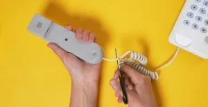 a person cutting the cord from their phone