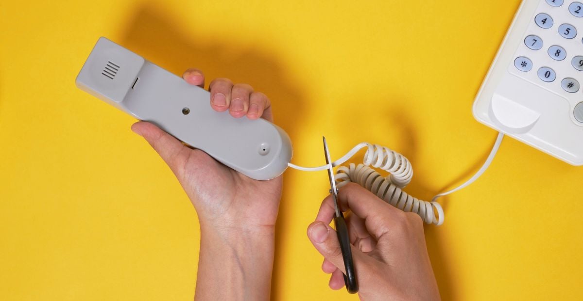 a person cutting the cord from their phone