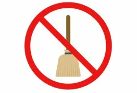 illustration of wicker-style "besom" broom inside a red interdictory circle aka no symbol on white background