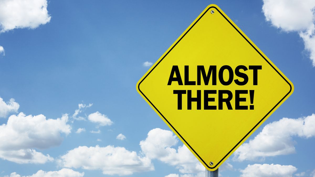 a yellow almost there sign