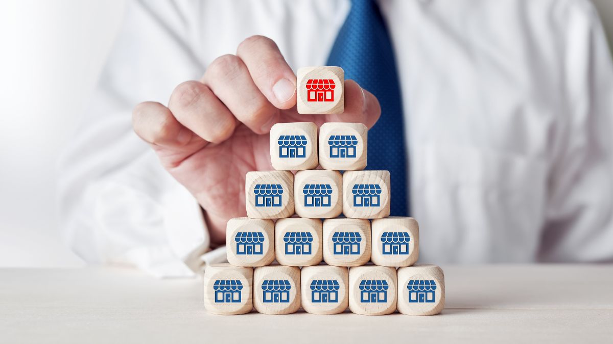 a series of cubes with homes on them being stacked into a pyramid