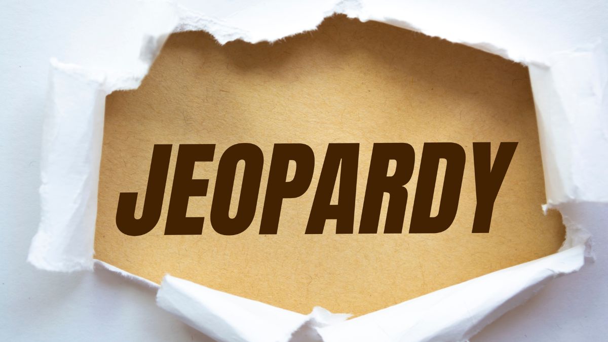 the word jeopardy appearing through a torn white background
