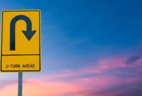 U-Turn Ahead Road Sign Sunset