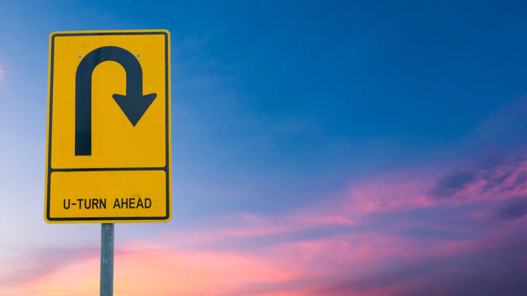 U-Turn Ahead Road Sign Sunset