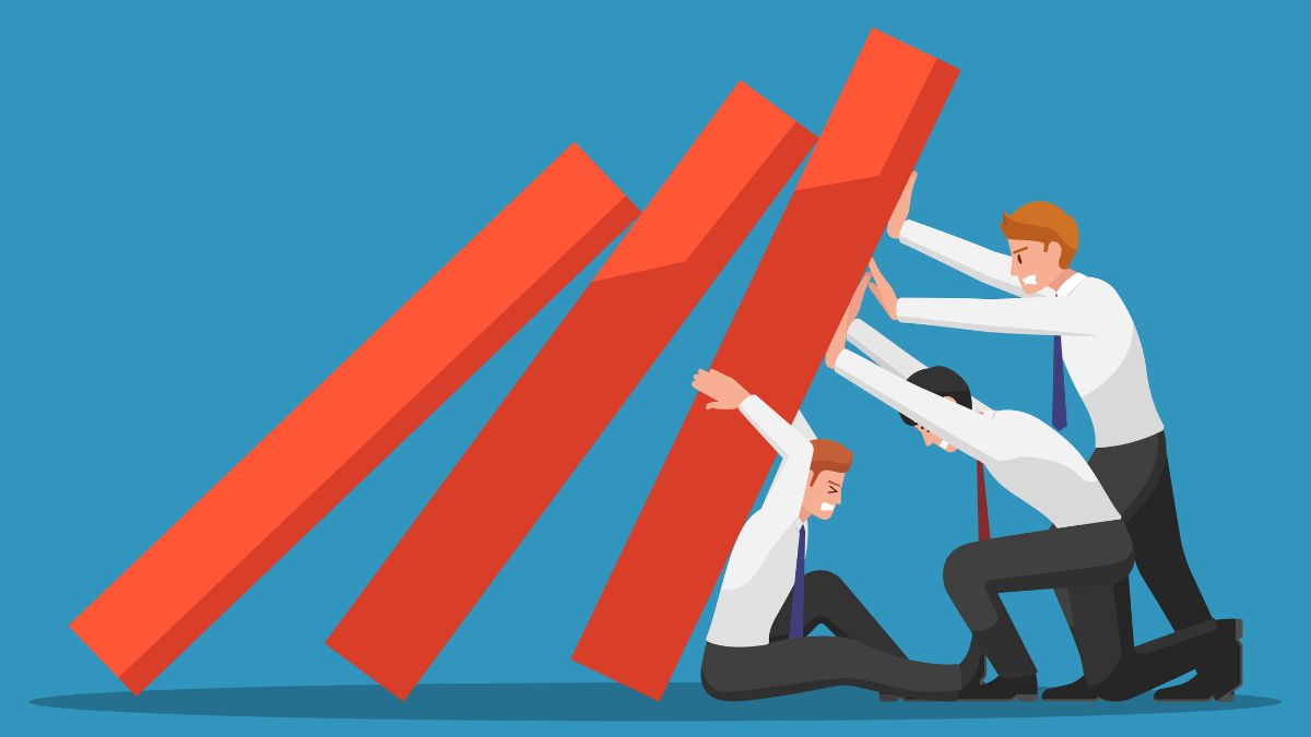 an illustration of three workers attempting to stop a set of dominos from tumbling over
