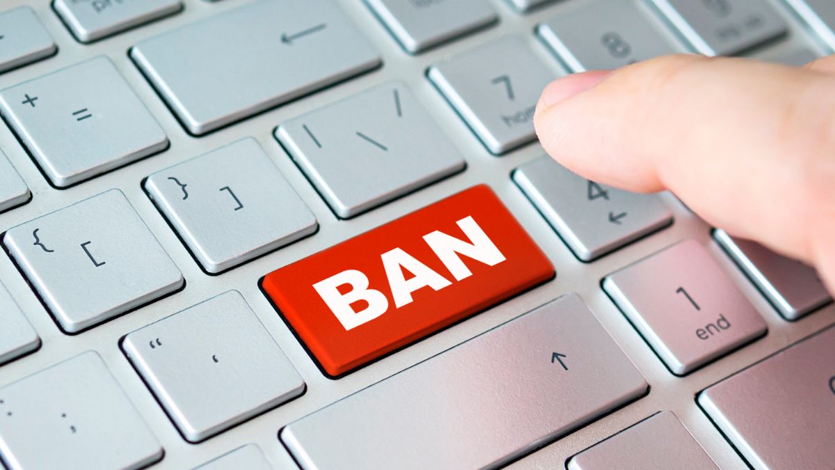 a keyboard with a red ban button about to be pressed