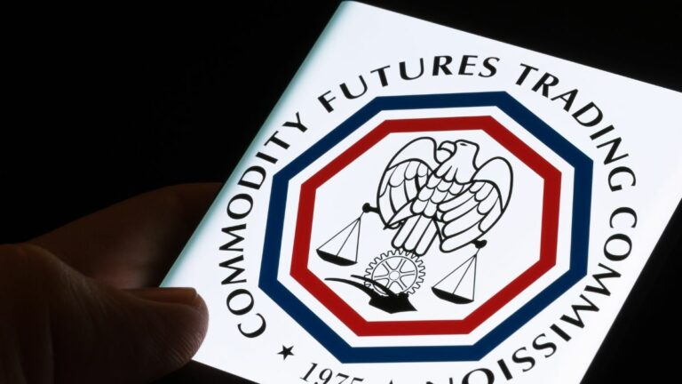 a person holding an image of the cftc logo