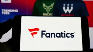 a mobile phone with the fanatics logo on it in front of the fanatics website