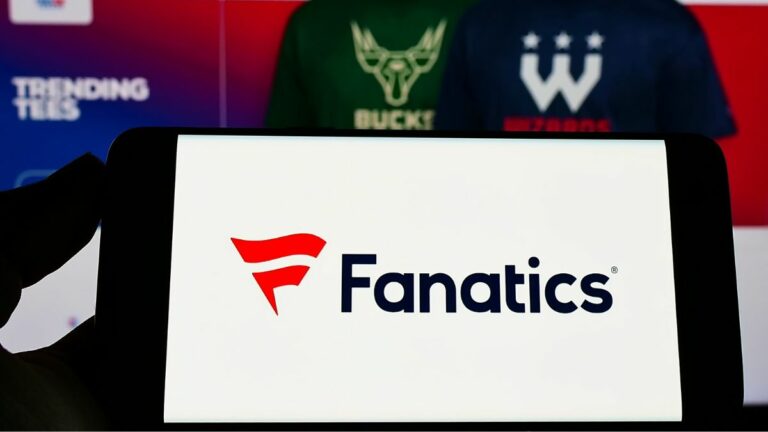 a mobile phone with the fanatics logo on it in front of the fanatics website