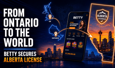 Promotional graphic announcing that Betty has secured an Alberta gaming license. Large white text on the left reads, “From Ontario to the World,” with smaller text below stating, “Betty Secures Alberta License.” The center features a smartphone displaying the Betty online casino app, including slots, live casino, table games, jackpots, featured games, and a jackpot amount. A stylized map highlights Ontario and the United Kingdom with location markers connected by glowing lines leading to Alberta on the right. Alberta is outlined in bright orange and filled with a city skyline at sunset beneath an “Alberta Licensed” badge. The background shows a modern city skyline reflected on water, with blue and orange neon accents throughout the design.