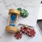 Blue poker chips on stock market chart background