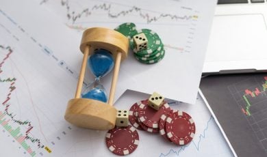 Blue poker chips on stock market chart background