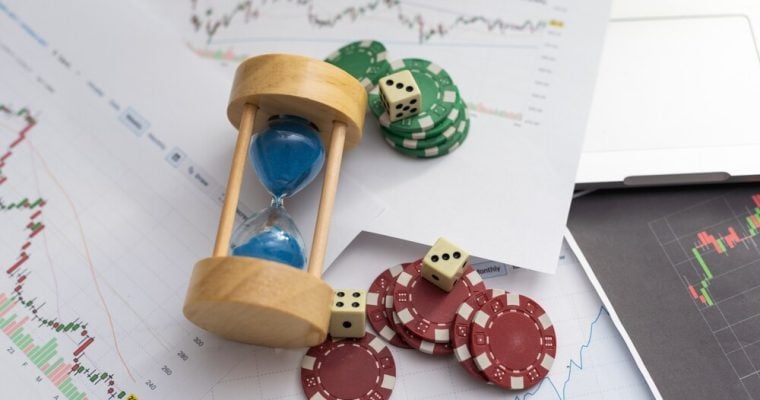 Blue poker chips on stock market chart background