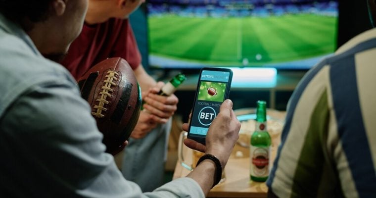 Legal sports betting on team in app on smartphone